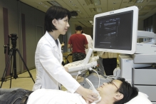 Professor Qing Zhang performs a demonstration of carotid artery ultrasound.