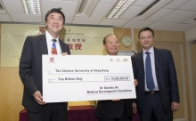 On behalf of Dr. Stanley Ho Medical Development Foundation, Mr. Patrick W.M. Huen presents the cheque to CUHK, received by Prof. Joseph J.Y. Sung.