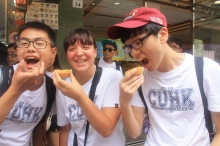 The international students sample local snacks in Hong Kong.