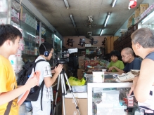 Mr. and Mrs. Ho, the owners of Wing Wo Pharmacy in Sai Ying Pun, are interviewed by two participating students.