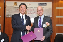 Prof. Joseph J. Y. Sung (left) and Prof. Andrew Hamilton shake hands after the agreement has been renewed.