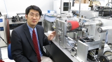 Prof. CHEN Shih-Chi, Department of Mechanical and Automation Engineering, CUHK and his precision roll-to-roll microcontact printing system.