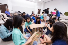 Students participating in the workshop of the Green Leadership Camp make a chair with waste paper, which can bear a human’s weight.