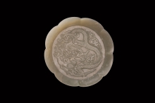 Eight-lobed dish with dragon motif in low relief
Liao Dynasty, 11th century CE
D: 15.5 cm (at rim) 12.8 cm (at base) H: 1.4 cm Thick: 0.2 cm