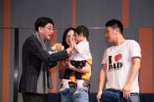 Dr. Wing-man KO, Secretary for Food and Health, HKSAR Government presents awards to the winning babies at the baby crawling competition.