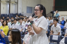 A member of the audience shares her views at the question and answer session.