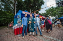 Kazakhstani students in traditional clothes holding a traditional musical instrument