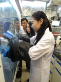 The team is operating experiment work at a laboratory. (From left) Dr. Guo-Ming Weng, Prof. Yi-Chun Lu and Ms. Zhejun Li.