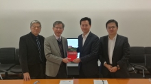 Prof. Walter Ho (1st left) and Prof. Raymond Yeung (2nd left) present Prof. Yeung’s book to Mr. Foster Wu (2nd right).