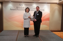 Mrs. Ingrid Yeung (left), Permanent Secretary for Education presented the Early Career Award certificate to Prof. Adam Kielman