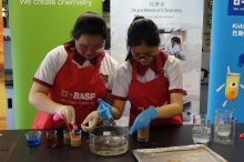 Helia Wong (left) and Phoebe Yeung (right) show the chemical process behind how liquids can be formed into spheres with the use of sodium alginate and calcium lactate.