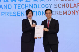 Chief Executive Mr John Lee (right) presents the Innovation and Technology Scholarship to Lucky Tsoi Lu-yi (left).