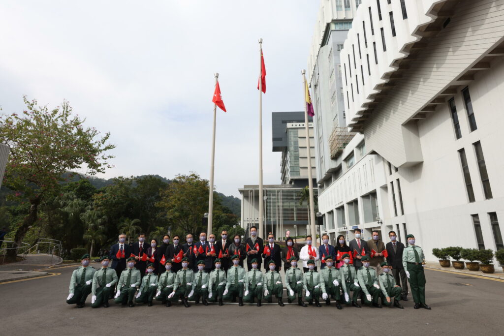 Guests pose for a group photo with the flag-raising team.