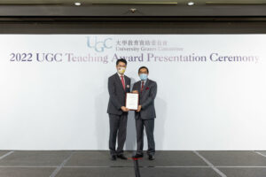 Professor Anthony So (left) receives the award certificate from Mr Carlson Tong, Chairman of UGC. (Photo provided by the organiser)