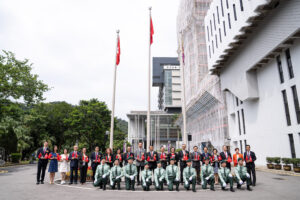 The University officers and guests pose for a group photo with the student flag-guard team.